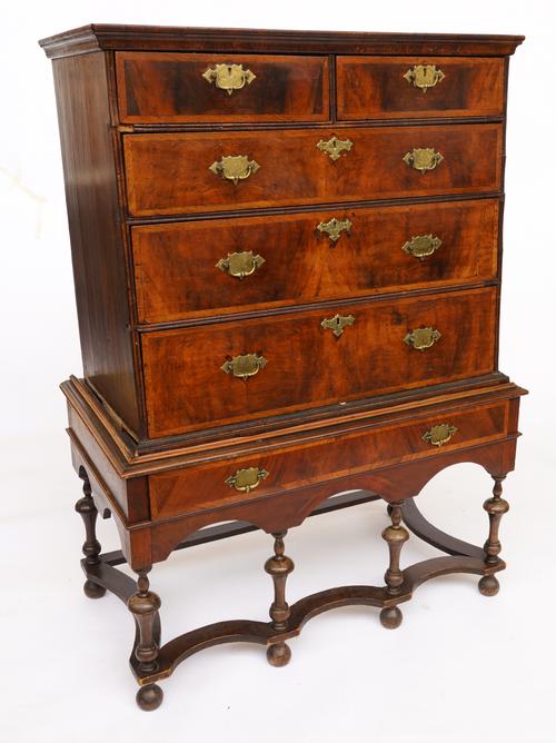 AN EARLY 18TH CENTURY FEATHER BANDED WALNUT AND OAK CHEST ON STAND