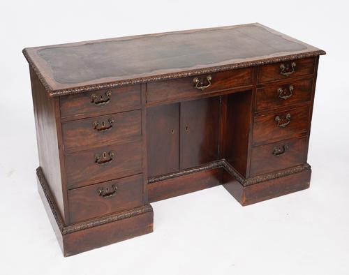 A GEORGE II MAHOGANY KNEEHOLE WRITING DESK
