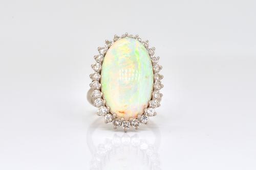 A WHITE GOLD, OPAL AND DIAMOND OVAL CLUSTER RING
