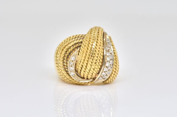 A GOLD AND DIAMOND RING IN A BOMBE WIREWORK DESIGN