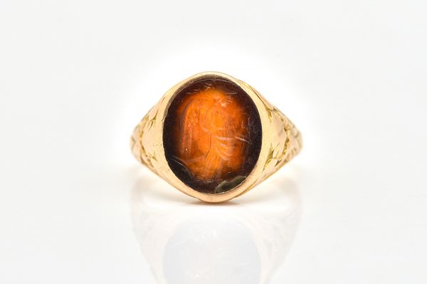 A VICTORIAN GOLD AND CORNELIAN OVAL SIGNET RING