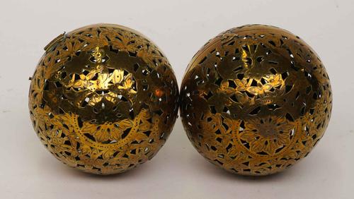 TWO SPHERICAL PIERCED AND ENGRAVED BRASS HAND WARMERS OR ROLLING LAMPS (2)
