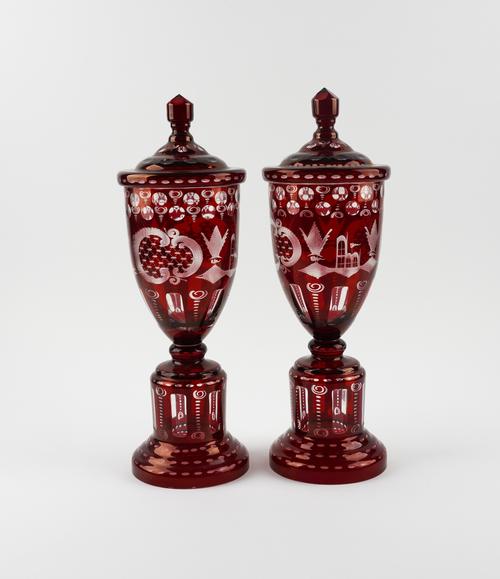A PAIR OF BOHEMIAN FLASH-RUBY GLASS URNS AND COVERS (2)