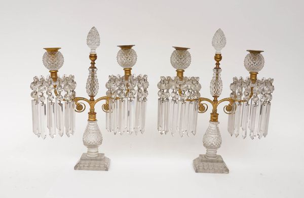 A PAIR OF REGENCY CUT-GLASS AND ORMOLU MOUNTED TWIN-LIGHT CANDELABRA (2)