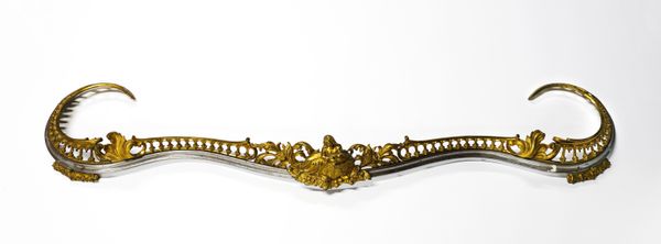 A VICTORIAN ROCOCO REVIVAL GILT-BRONZE MOUNTED SERPENTINE CURB FENDER