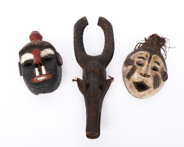 AN IBO MASK, NIGERIA, A BOBO ANTELOPE MASK, BURKINA FASO AND ANOTHER WEST AFRICAN MASK (3)