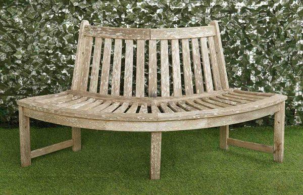 A HARDWOOD SEMI-ELLIPTIC SLATTED TREE GUARD BENCH