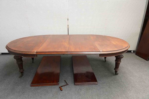 A VICTORIAN MAHOGANY OVAL EXTENDING DINING TABLE