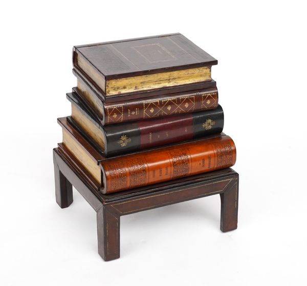 MAITLAND-SMITH; A NOVELTY OCCASIONAL TABLE FORMED AS A STACK OF LEATHER BOUND BOOKS