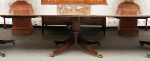 A GEORGE III STYLE MAHOGANY TRIPLE PILLAR EXTENDING DINING TABLE