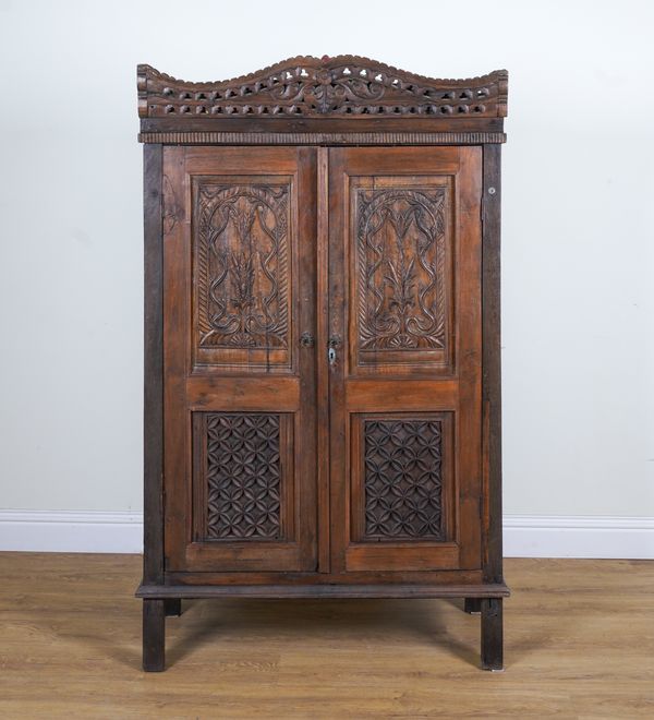 AN ANGLO INDIAN TEAK TWO DOOR ARMOIRE