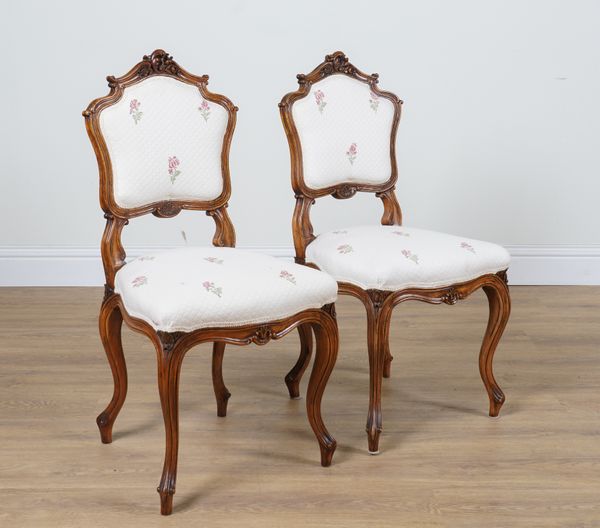 A PAIR OF LOUIS XV STYLE WALNUT FRAMED SIDE CHAIRS (2)