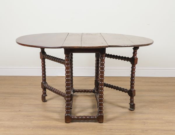 A 17TH CENTURY YEW WOOD GATE LEG TABLE