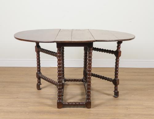 A 17TH CENTURY YEW WOOD GATE LEG TABLE