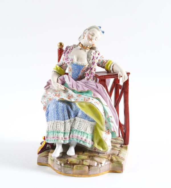 A MEISSEN FIGURE OF A SEATED WOMAN