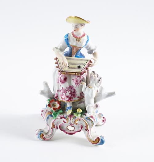 A BOW FIGURE OF FEMALE MUSICIAN