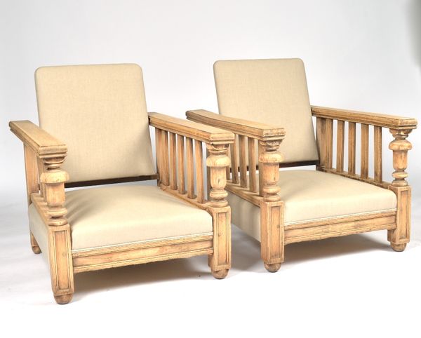 A PAIR OF MID-20TH CENTURY STRIPPED OAK EASY ARMCHAIRS (2)