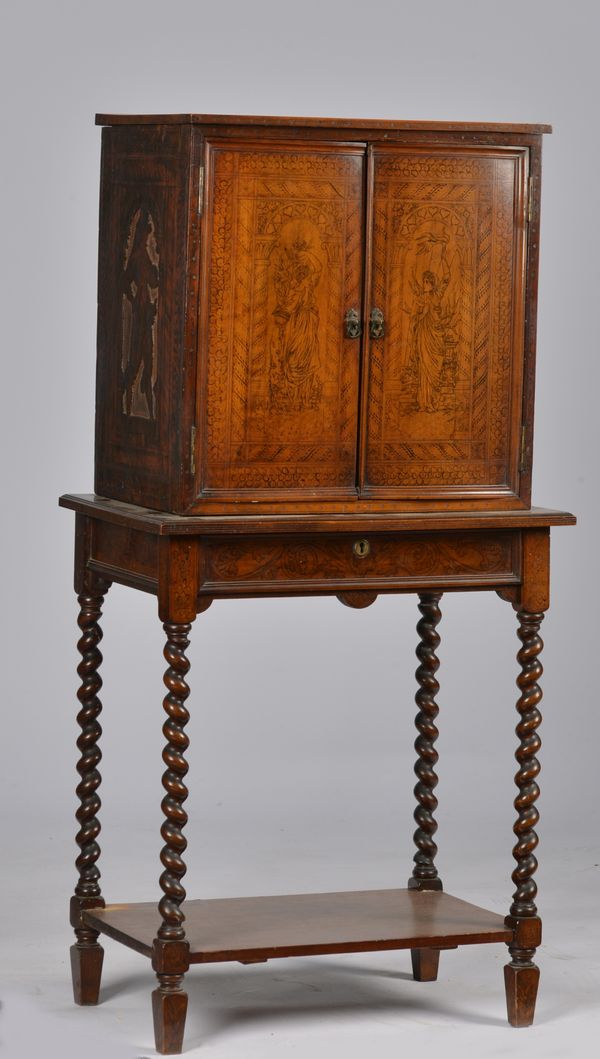 A SMALL VICTORIAN WALNUT PENWORK DECORATED CABINET ON STAND