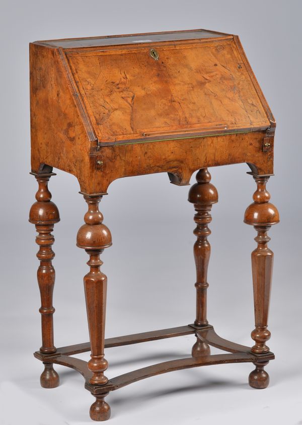 A QUEEN ANNE AND LATER FIGURED WALNUT BUREAU