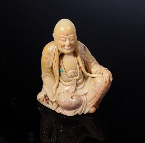 A CHINESE SOAPSTONE CARVING OF A LUOHAN