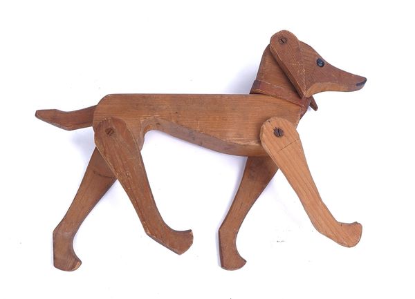 A WOODEN TOY MODEL OF A DOG