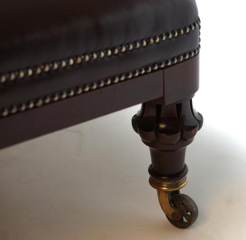 A LARGE TAN LEATHER UPHOLSTERED RECTANGULAR FOOTSTOOL