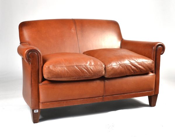 LAURA ASHLEY; A SMALL TAN LEATHER TWO SEAT SOFA