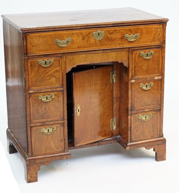 A GEORGE II WALNUT KNEEHOLE DESK