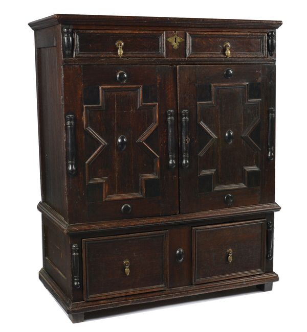 A CHARLES II RAISED GEOMETRIC MOULDED OAK CHEST