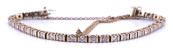 A GOLD AND DIAMOND SET LINE BRACELET