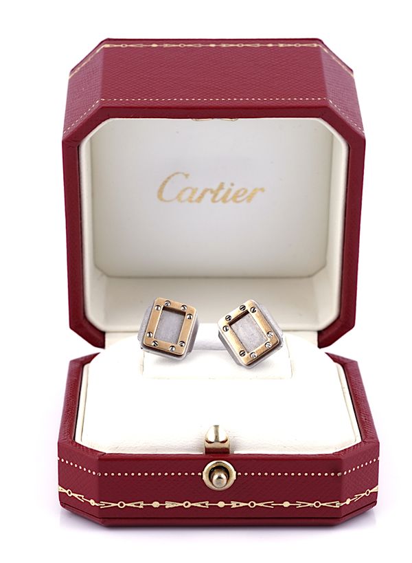 A PAIR OF STAINLESS STEEL AND GOLD CUFFLINKS BY CARTIER