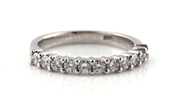 A PLATINUM AND DIAMOND SET HALF ETERNITY RING