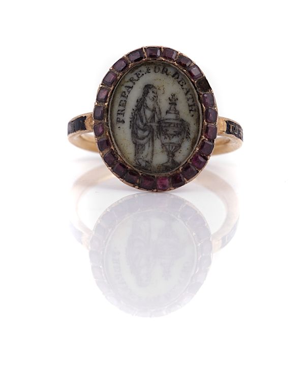 A GOLD AND GARNET MOURNING RING