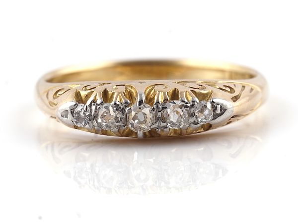 A GOLD AND DIAMOND FIVE STONE RING