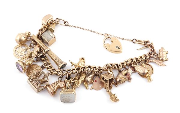 A GOLD CURB LINK CHARM BRACELET