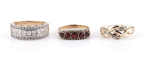 A 9CT GOLD AND GARNET FIVE STONE RING AND TWO FURTHER 9CT GOLD AND GEM SET RINGS (3)