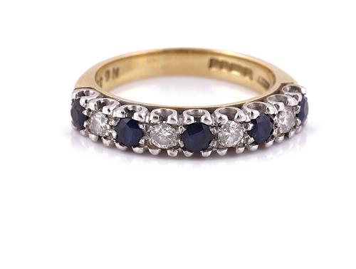 AN 18CT GOLD, SAPPHIRE AND DIAMOND NINE STONE HALF HOOP ETERNITY RING