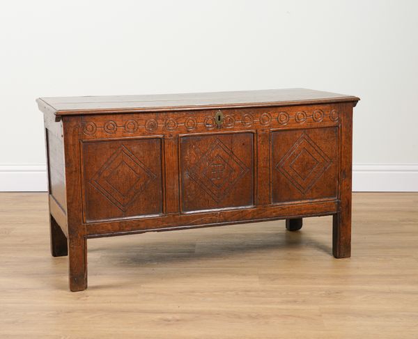 A 17TH CENTURY CARVED OAK TRIPLE PANEL COFFER