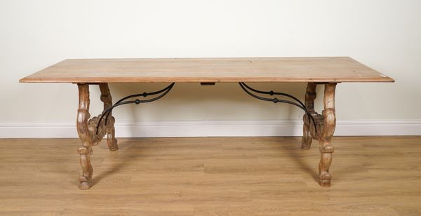 A 19TH CENTURY SPANISH PINE RECTANGULAR DINING TABLE ON DUAL CARVED SUPPORTS