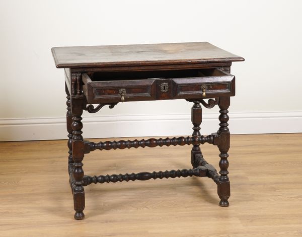 A CHARLES II AND LATER SINGLE RAISED PANEL DRAWER SIDE TABLE ON BOBBIN SUPPORTS