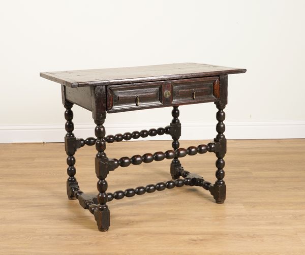 A CHARLES II OAK RAISED PANEL SINGLE DRAWER SIDE TABLE ON BOBBIN SUPPORTS