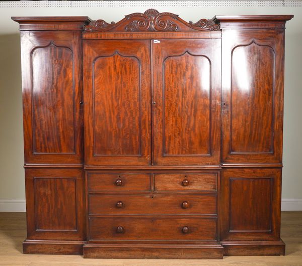 A REGENCY MAHOGANY TRIPLE SECTION COMPACTUM WARDROBE