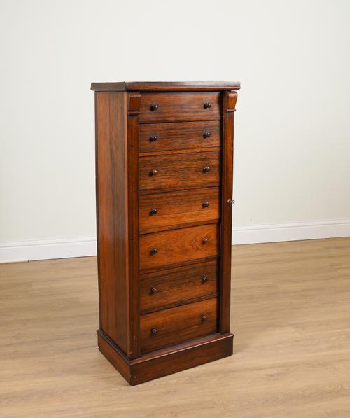 A 19TH CENTURY ROSEWOOD SEVEN DRAWER WELLINGTON CHEST ON PLINTH BASE