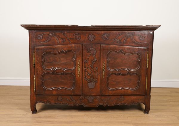 AN EARLY 19TH CENTURY FRNCH CARVED OAK TWO DOOR SIDE CUPBOARD