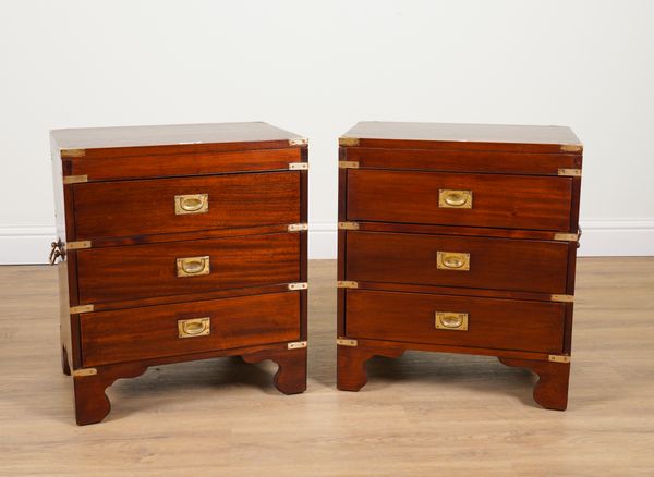 A PAIR OF CAMPAIGN STYLE BRASS BOUND MAHOGANY THREE DRAWER BEDSIDE TABLES (2)