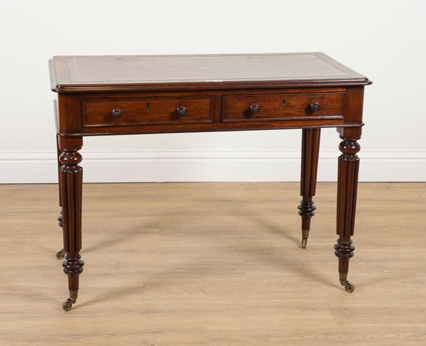 A MID 19TH CENTURY MAHOGANY TWO DRAWER WRITINGS DESK ON REEDED SUPPORTS