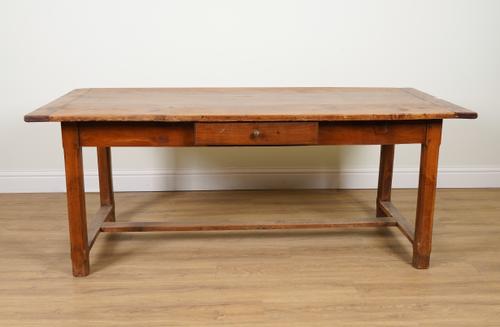 AN EARLY 19TH CENTURY FRENCH CLEATED PLANK TOP FRUITWOOD KITCHEN TABLE ON STOP CHAMFERED BLOCK SUPPORTS