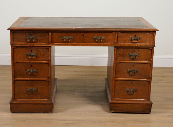 JAS SHOOLBRED AND CO; A 19TH CENTURY OAK NINE DRAWER PEDESTAL DESK