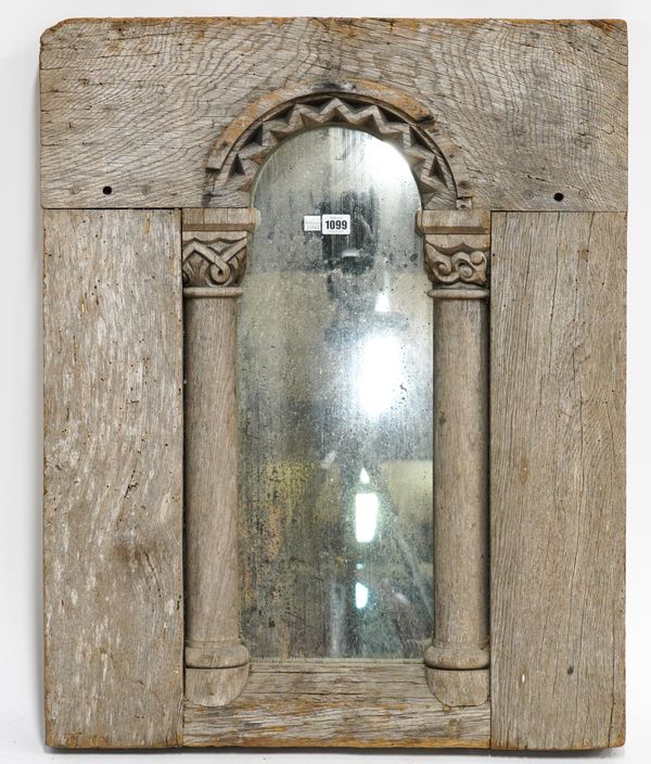 A STRIPPED OAK WALL MIRROR WITH CARVED CAPITAL COLUMN DECORATION