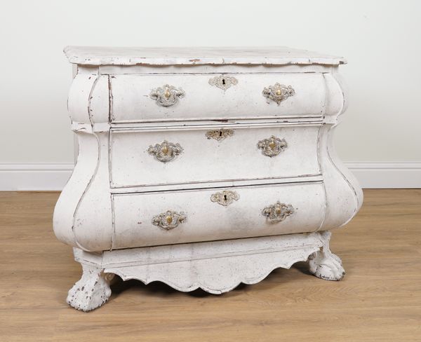 AN EARLY 19TH CENTURY DUTCH LATER DISTRESSED WHITE PAINTED BOMBE THREE DRAER COMMODE ON BALL AND CLAW FEET